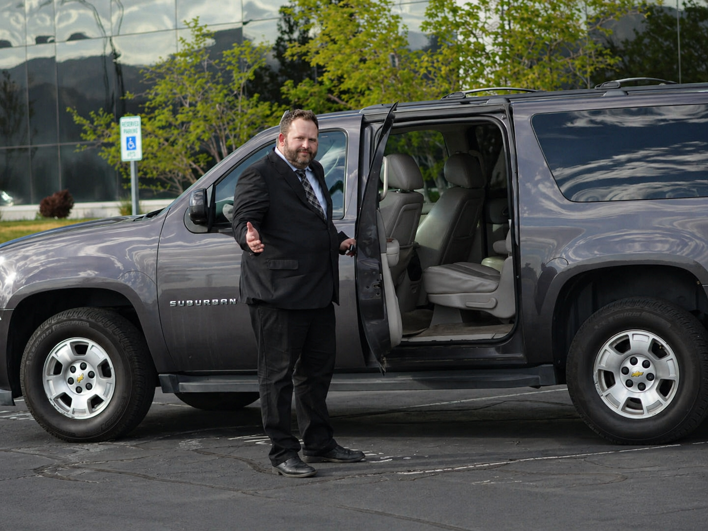 Adam opening the door of a private SUV