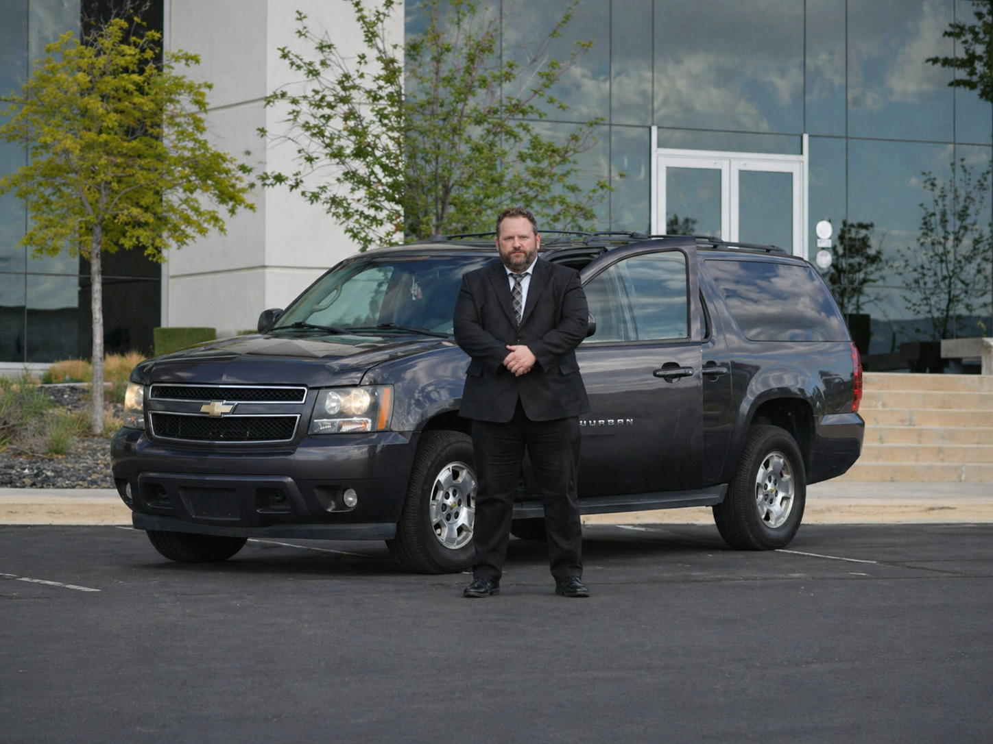 Adam standing in front of the long-distance service SUV