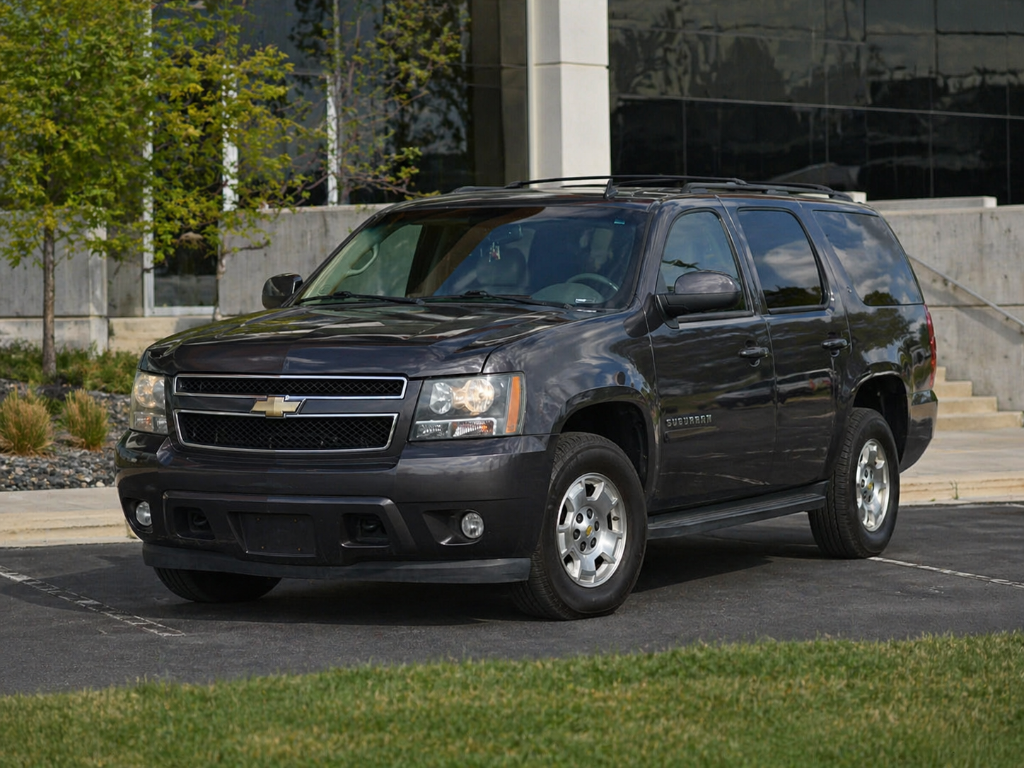Black SUV parked outside a professional building